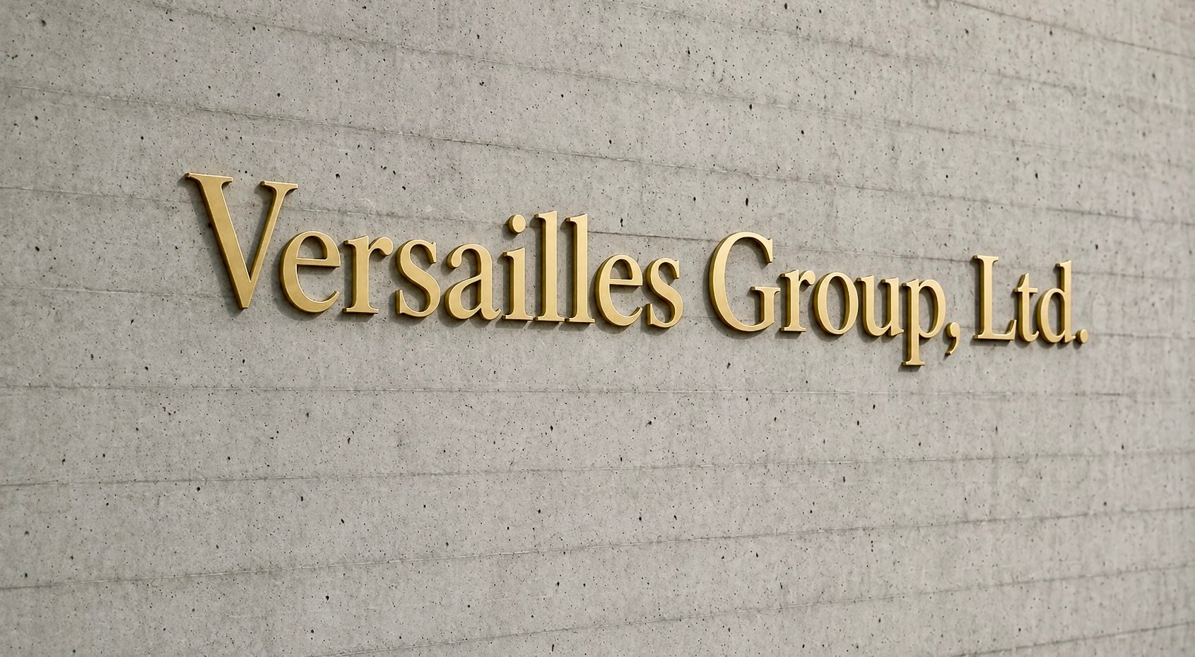Versailles Group sign on concrete wall